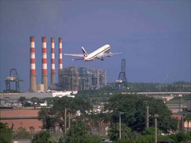 jet taking off over an industrial cityscape