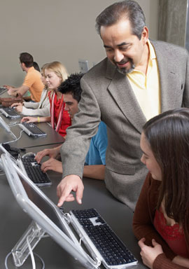 instructor with students in a computer lab